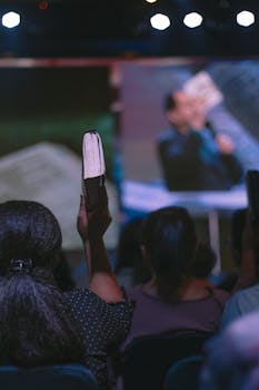 Audience member raises a book during a public event in Jakarta, Indonesia.